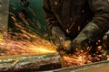 Welder welding metal in workshop with sparks Royalty Free Stock Photo