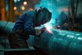 A welder welding a pipe Royalty Free Stock Photo