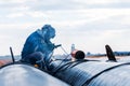 The welder is welding with shielded metal arc welding SMAW or manual metal arc welding process to eyebolt on the pipe in the con Royalty Free Stock Photo