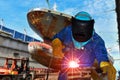 Welder is welding in shipyard