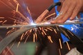 Welder is welding steel flat bar without safety glove