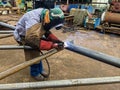 Welder Welding Steel Pipe for Steel Structure Work with Process Flux Cored Arc Welding (FCAW) Royalty Free Stock Photo