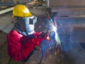 Welder welding a steel plate for steel structure work with process Flux Cored Arc Welding(FCAW) Royalty Free Stock Photo