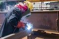 Welder is welding a steel plate for steel structure work with process Flux Cored Arc Welding& x28;FCAW& x29; Royalty Free Stock Photo