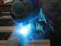 Welder is welding steel structure with all safety equipment in factory Royalty Free Stock Photo