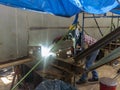 The welder is welding a steel structure work with process Flux Cored Arc WeldingFCAW Royalty Free Stock Photo