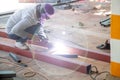 The welder is welding the structure on the floor Royalty Free Stock Photo