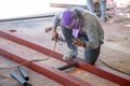 The welder is welding the structure on the floor Royalty Free Stock Photo