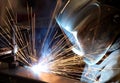 A welder joining two pieces of metal in a metal fabrication facility