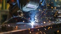 welder is welding in the workstation, welder at the workstation, welder doing hard work in garage Royalty Free Stock Photo