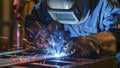 welder is welding in the workstation, welder at the workstation, welder doing hard work in garage Royalty Free Stock Photo