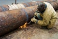Welder welds pipe segments. Repair and replacement of outdated p Royalty Free Stock Photo