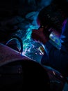 A welder welds pipes by emitting a beautiful glow Royalty Free Stock Photo