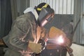 A welder welds technological pipelines with manual arc welding for an oil refinery in Russia. Welded joint