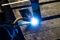 Welder at work in an electromechanical workshop