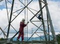 Welder work at high Electric high voltage pole 230 Kv. Royalty Free Stock Photo