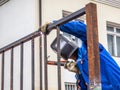 Welder at work mounting metal structures - metal fence. Royalty Free Stock Photo