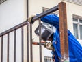 Welder at work mounting metal structures - metal fence.