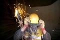 welder worker hanging working at height wearing helmet using face shield safety equipment protection