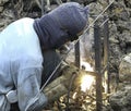 Welder worker male welding steel for make foundation piles in pit Royalty Free Stock Photo