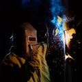 Welder worker welding metal by electrode Royalty Free Stock Photo