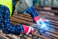 Welder worker welding metal by electrode