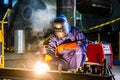 Welder working in industrial factory