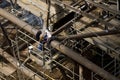 A welder working on a massive steel jacket -the first installed section of an offshore platform High view