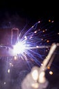 Welder working on a metal structure fixing an urgent problem on the night shift close-up, front and back background blurred with Royalty Free Stock Photo