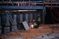 Welder working on the road bridge construction