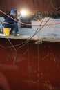 Welder working on side of ship in dry dock