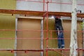 Welder works at the building of a house