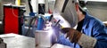 Welder works in metal construction - construction and processing