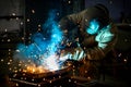 Welder works with a metal product. Beautiful sparks in the dark