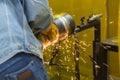 The welding craftsman grinding the steel tube