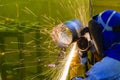 The welding craftsman grinding the steel tube