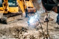 welding details, sparks on construction site excavator