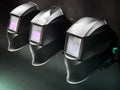 Welding helmets displayed in a workshop under dim lighting, showcasing protective gear for metalworking tasks Royalty Free Stock Photo