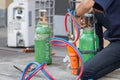 Welding hose, Air conditioning repair man install pressure gauge on fuel gases and oxygen tank to weld or cut