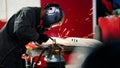 Welding industrial: worker in helmet repair detail in car auto service Royalty Free Stock Photo