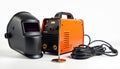 Welding machine and protective mask on white background. Includes cables and electrode holder. Professional tool for metalwork Royalty Free Stock Photo