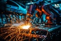 Welding machines join the body of a modern car at the automotive factory.