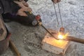 Worker cutting steel pipe using metal torch