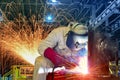 Industrial worker welding in factory. Royalty Free Stock Photo