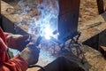 Welding metal and wood by electrode with bright electric arc