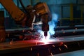 welding robot with a metal piece glowing redhot