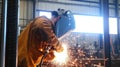 Welding sparks illuminate workshop as skilled worker fabricates metal structures in bright industrial environment Royalty Free Stock Photo