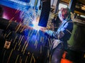 welding worker, while works standing up in a metalworking factory