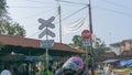 A STOP (BERHENTI) sign and a DOUBLE-TRACKS RAILWAY (PERLINTASAN KA JALUR GANDA)