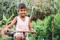 Weligama, Sri Lanka - December 21 , 2017: Little barefoot boy st